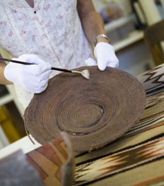 An NHMU Curator prepares an anthropology artifact