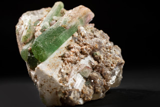 A specimen of bicolored elbaite with lepidolite mica and quartz.