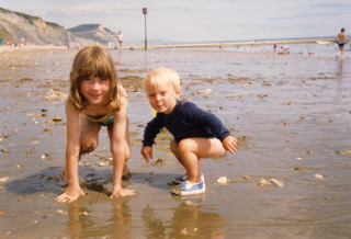 Susannah Maidment as a child on the beach alongside her brother.