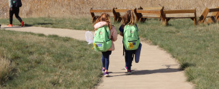 Two students walk side by along Bear River Nature Center walkways.