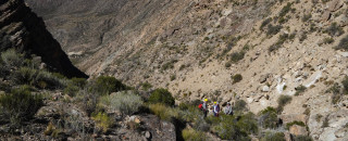 Team members hiking among the rugged outcrops of the Santa Clara study area.